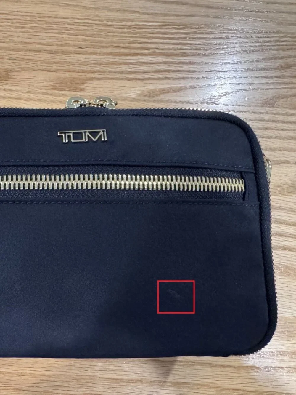 Authentic TUMI Voyageur Langley Crossbody in black with gold-tone hardware
